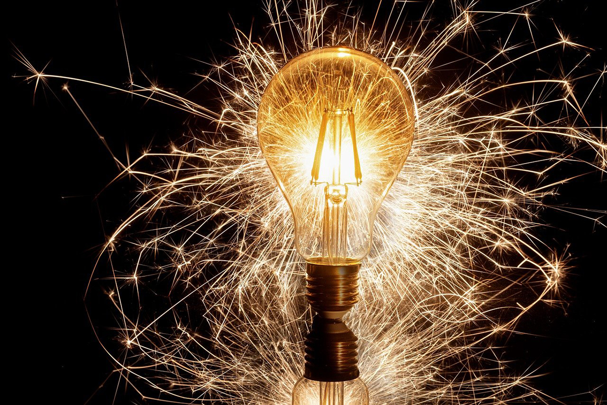 A light bulb with sparklers behind it